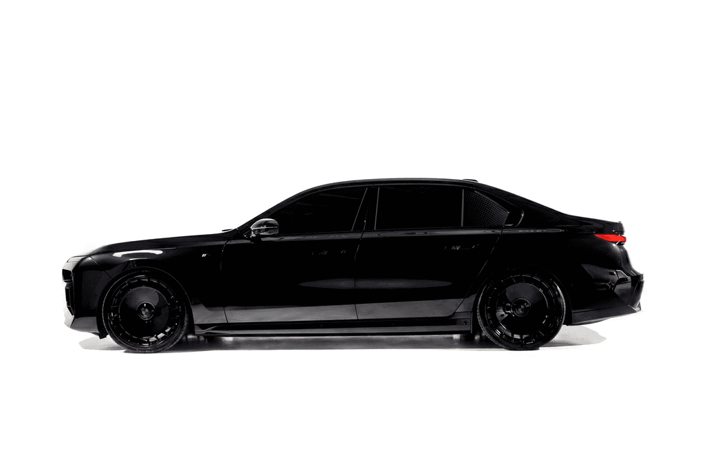 Black BMW i7 on solid disc wheels, in side profile against a white studio sweep