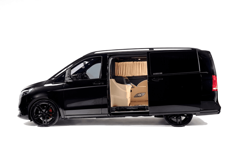 Black Mercedes-Benz V-Class with the side door open on a cream leather cabin, against a white studio sweep