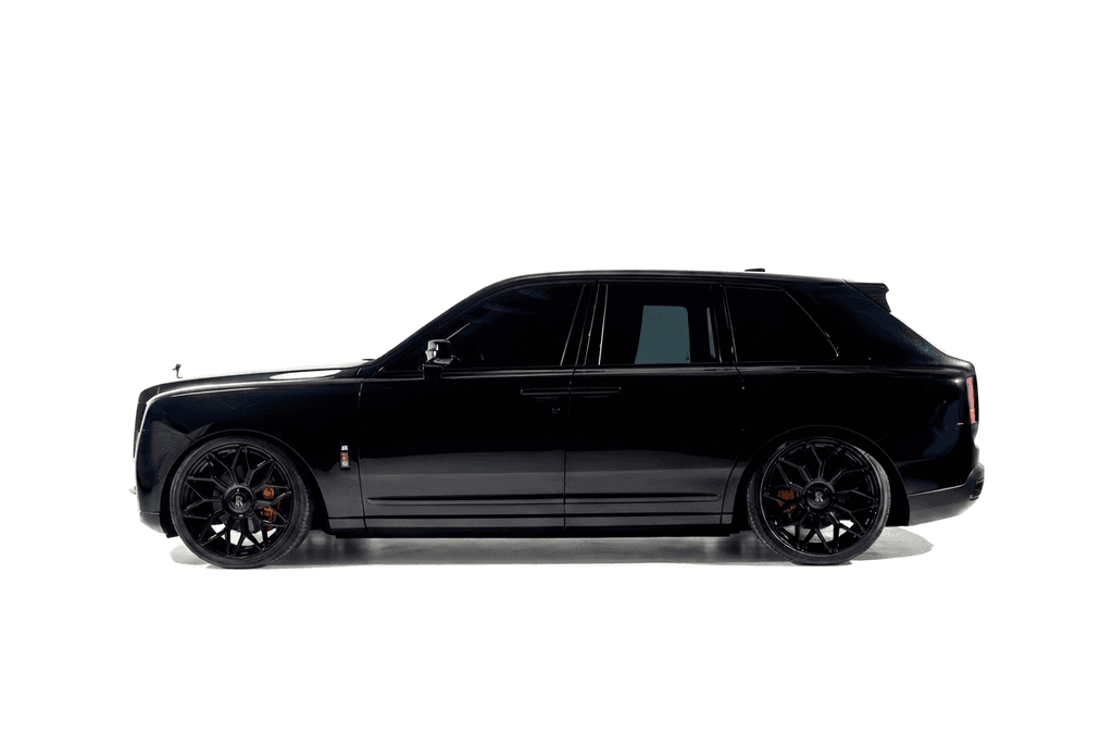 Black Rolls-Royce Cullinan in side profile against a white studio sweep